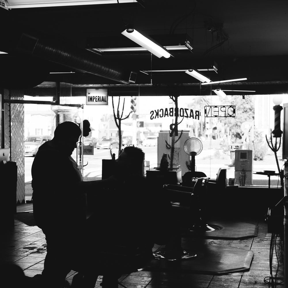 Inside Razorbacks Barber Shop in black and white